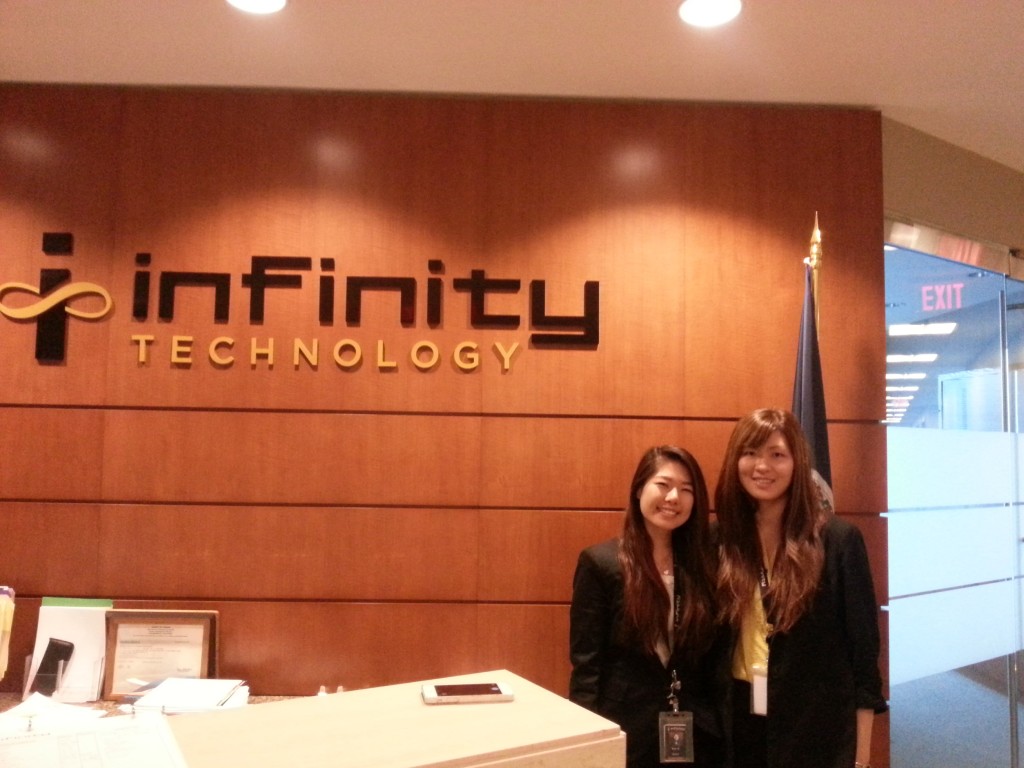 Me and the other intern, Anna Chen, in front of our company logo.